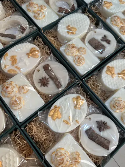 A closer look at the contents of the 80th birthday favor boxes. The all-white-and-gold theme with custom tags makes for a very elegant and personalized gift.