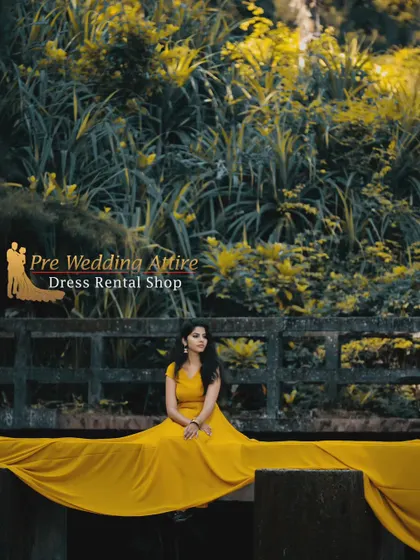 Our mustard yellow trail gown spread across a bridge. This gown's warm, vibrant color is perfect for outdoor shoots and stands out beautifully against natural foliage.