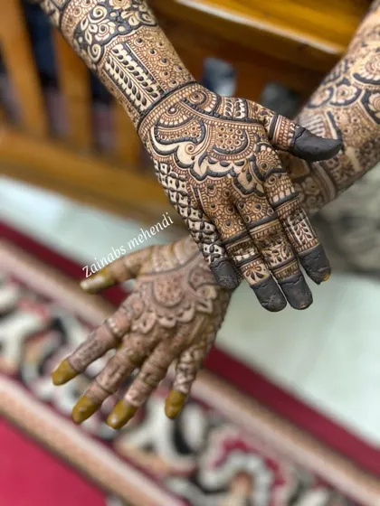 Another view of Hibah's stunning Pakistani henna, showcasing the detailed patterns on both hands.