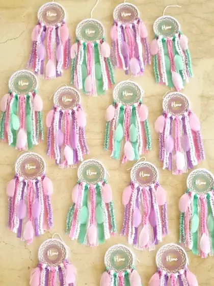 We were thrilled to create this bulk order of 32 pastel dreamcatchers for a housewarming ceremony. Each one was customized with the word 'Home' to celebrate the new journey.
