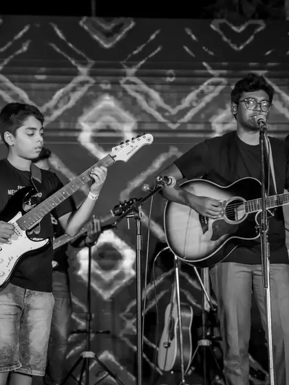A black and white shot capturing the intensity of a student guitar performance at our showcase. These are the moments where artists are born.
