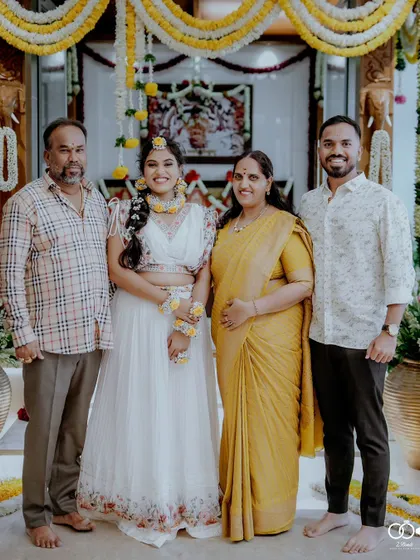 A lovely family portrait of the bride with her parents and brother on the day of her Haldi ceremony.