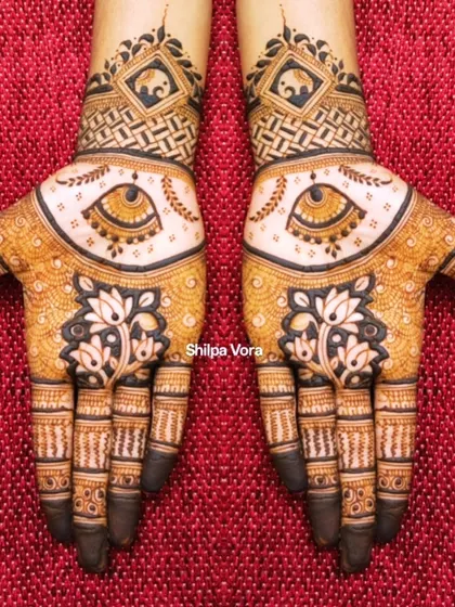 An elegant design featuring the evil eye motif for protection, surrounded by lotus flowers and elephant figures.