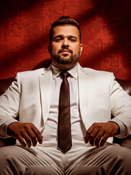 A powerful, seated portrait with dramatic lighting. This image reflects the serious focus and passion I have for music production and the art of DJing.