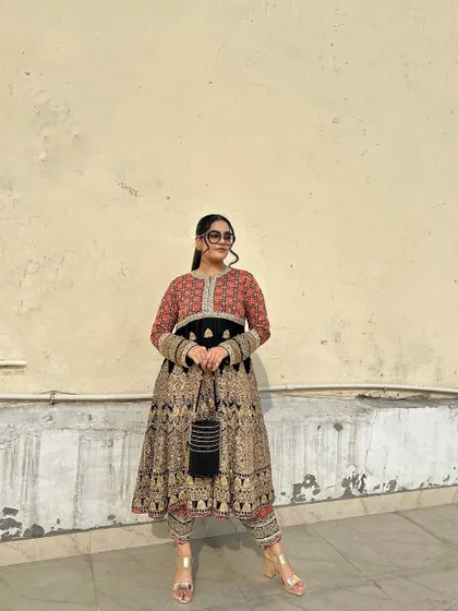 The empire waistline and voluminous flare of this Anarkali create a regal and timeless look.