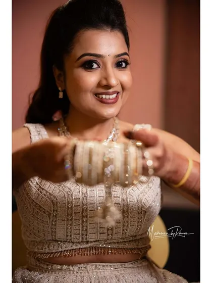 A fun, playful shot of the bride with her bangles.