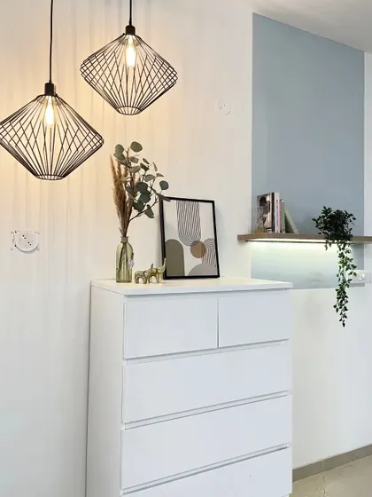A repeat of the minimalist corner with the white drawers and black pendant lights.