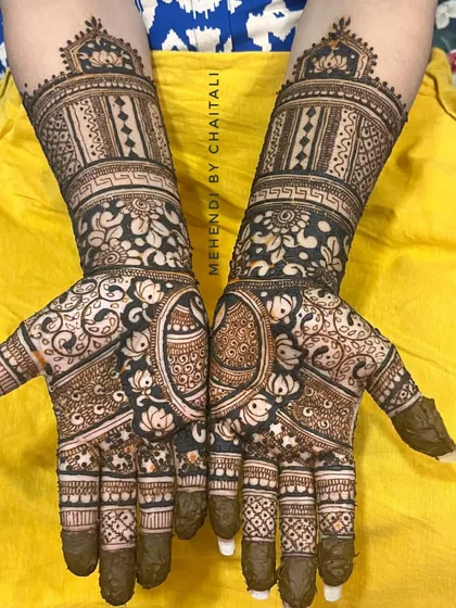 This is a semi-bridal mehendi design, perfect for a bride who wants intricate work that is less extensive than a full-arm design. It features dense patterns on the hands and a detailed cuff on the wrist.