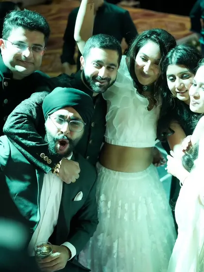 A fun group hug on the dance floor. Capturing the bond between friends is just as important as the couple's portraits.