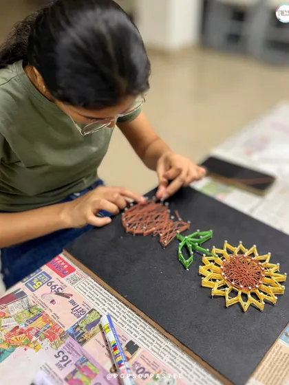 A different angle showing the intricate weaving process for the sunflower's center and stem.