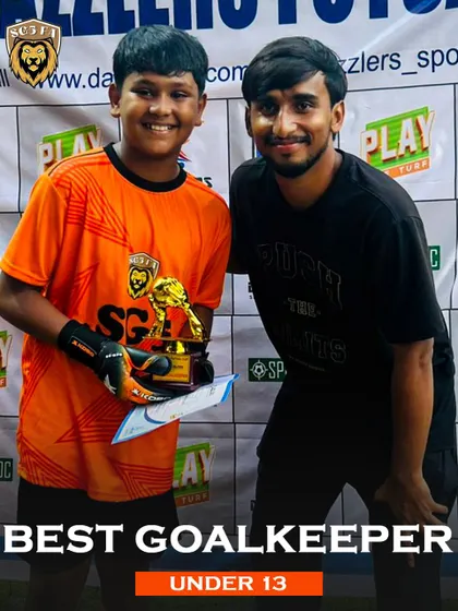 Our Under 13 Best Goalkeeper from the Dazzlers Futsal Cup, posing with his coach. This highlights our focus on specialized position training.