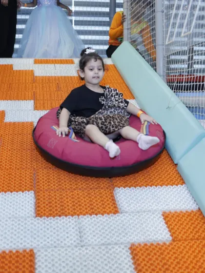 Here we go. A young guest enjoys a ride down our popular doughnut slide. This unique slide provides a fun and gentle thrill for kids of various ages.