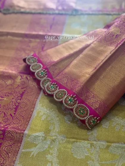 The sleeve cuff of the pink blouse, showing a continuous line of the motifs.