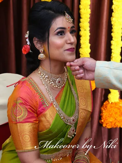 A complete look at Nirosha's engagement style. She wore a vibrant silk saree, and we created a soft glam look with a pretty pink lip and a chic updo.