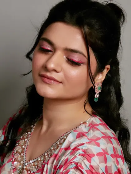 A student's work featuring a bold pink eyeshadow look, perfect for a Sangeet or cocktail event.