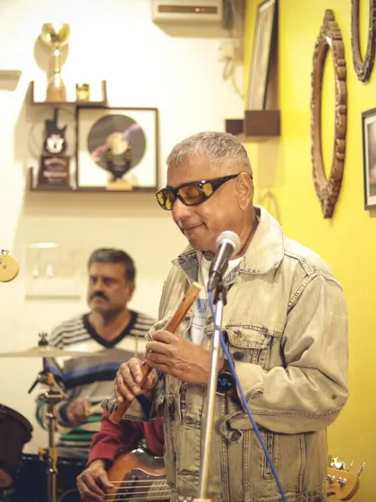 A flutist from the band Blues Ghat adding a unique melodic layer to their performance. We celebrate the fusion of different musical traditions on our stage.