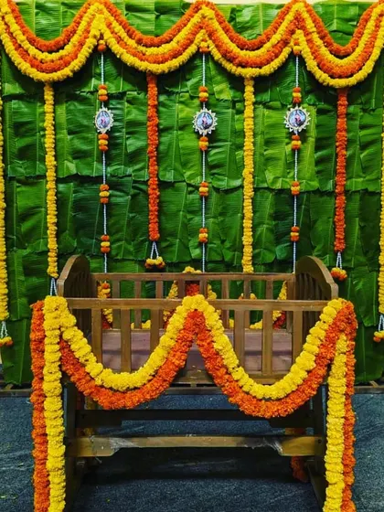 A very traditional naming ceremony setup. We used a backdrop of fresh banana leaves and decorated the wooden cradle with garlands of orange and yellow marigolds.