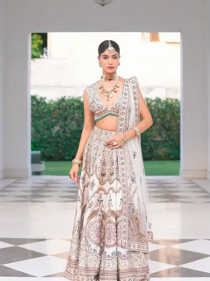 A classic shot in a grand corridor, the Laila lehenga looks perfectly at home in a palace setting.