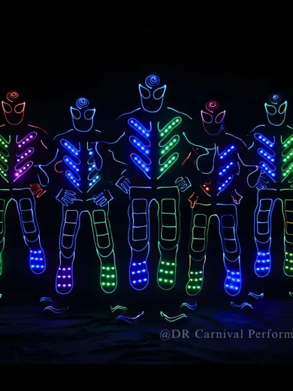 Our full Tron squad assembled and ready to perform. The vibrant colors of their suits stand out against the darkness, promising an electric show.