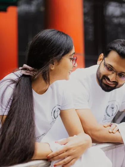 A quiet conversation on a campus walkway. This image captures the everyday moments of their relationship, showing that love is often found in the simple, shared experiences.