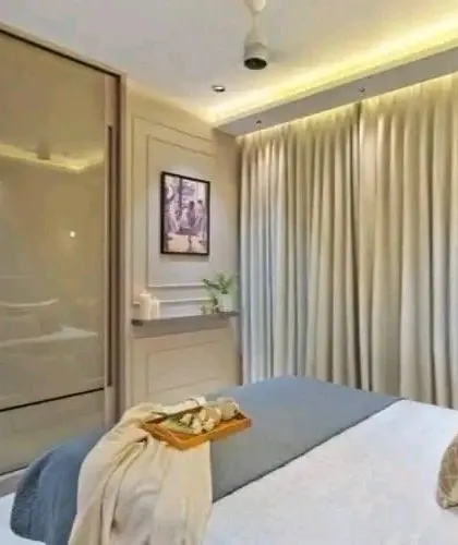 This bedroom features a sliding wardrobe with a glossy finish, which is a great space-saver for compact rooms.