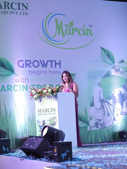 On stage for Marcin Crop Care, where "Growth begins here." I adapt my hosting to fit any industry, including agriculture.