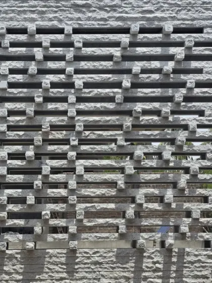 The granite jaali of the Tiruppur house, a symphony in stone. The perforated screen creates a beautiful play of light and shadow, while providing privacy and ventilation.