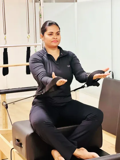 A client performs an exercise on the Pilates reformer at our studio in Whitefield. Pilates is excellent for building core strength, improving posture, and rehabilitating injuries in a controlled, low impact way.