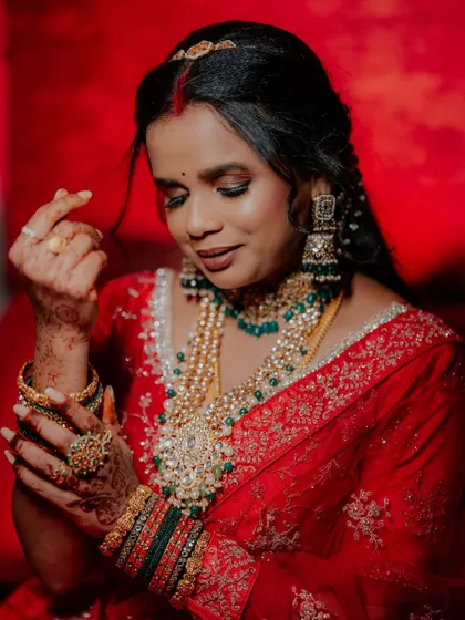A detailed portrait of the bride, showcasing her stunning layered necklaces and earrings.