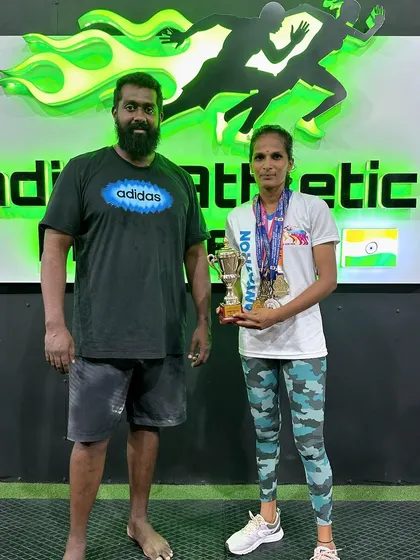 Celebrating our marathon champion. Here is one of our dedicated athletes with her coach and her trophy, showcasing the results of consistent training.