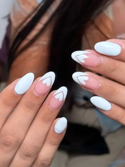 A different angle of the white and negative space heart design. It's a chic and minimalist way to do heart-themed nails.
