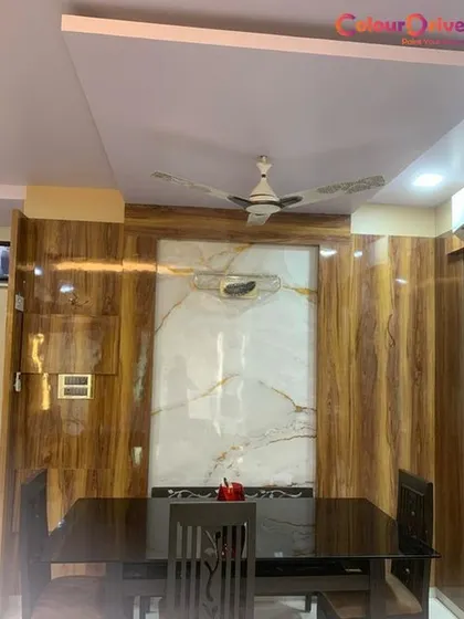 This dining area showcases our high-gloss wood-look paneling and a central marble-finish feature wall. We provide specialized painting and finishing services to create luxurious and unique interior designs that elevate your home.