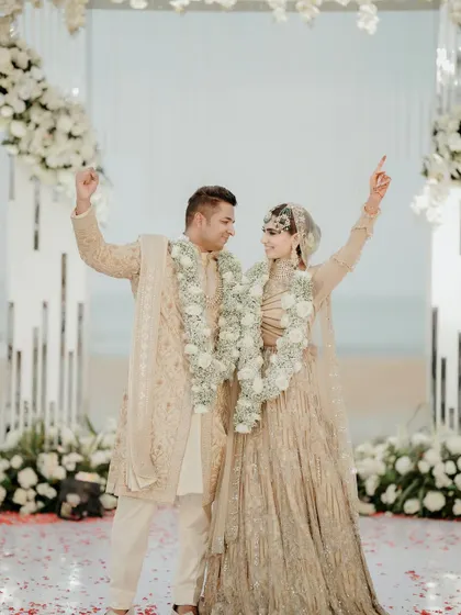 The couple celebrating after their Nikah ceremony. Their coordinated outfits and joyful expressions are just perfect.