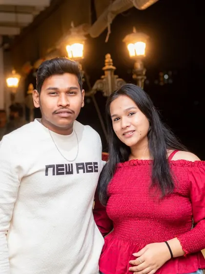 A stylish couple posing on the rooftop, perfect for a date night.