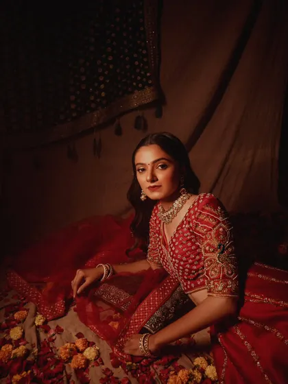 A wider shot from the bridal campaign, showing the model in a beautifully arranged setting of flowers and fabrics.
