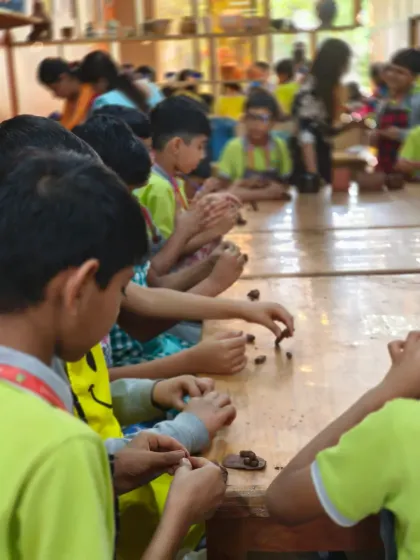 Young students are focused on their creations, learning to shape and mold miniature clay articles. We provide a hands-on learning environment that fosters concentration and creativity.
