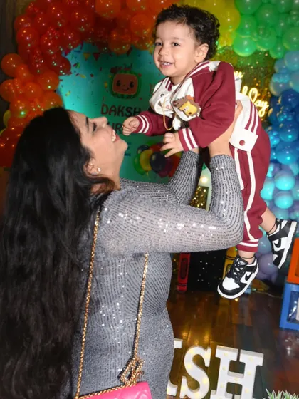A joyful shot of a mother lifting her son in the air. The happiness on both their faces is infectious.