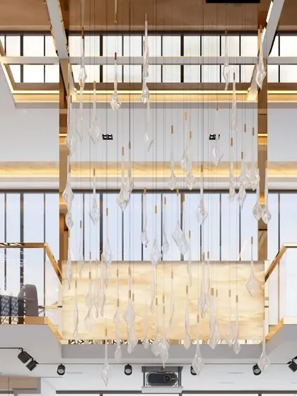 A view looking up at the double-height ceiling, showcasing a stunning custom crystal drop chandelier. This fixture acts as a major statement piece, visible from both levels of the executive floor.