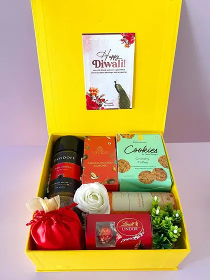 A premium curation in our bright yellow box, this hamper includes Davidoff coffee, cookies, Lindt chocolate, and other gourmet treats.