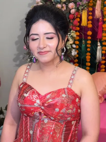 A close-up of Rashmi's Mehendi makeup. The soft pink tones on her eyes and lips create a look that is pretty and romantic.