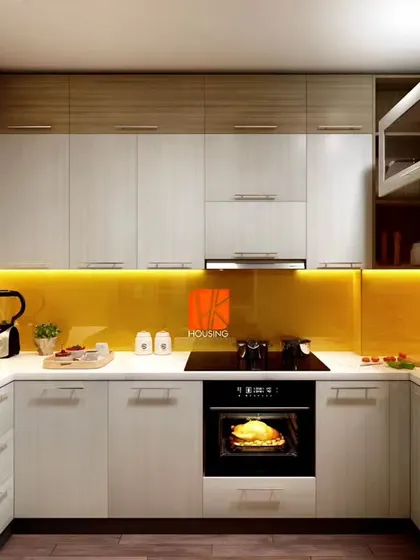 A compact U-shaped kitchen with a bright yellow backsplash that adds a cheerful touch to the neutral cabinets.