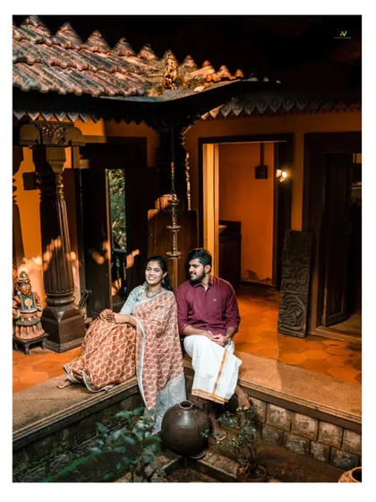 A beautiful portrait of a couple in a traditional courtyard, capturing the warm, ambient light and vintage feel of the location.