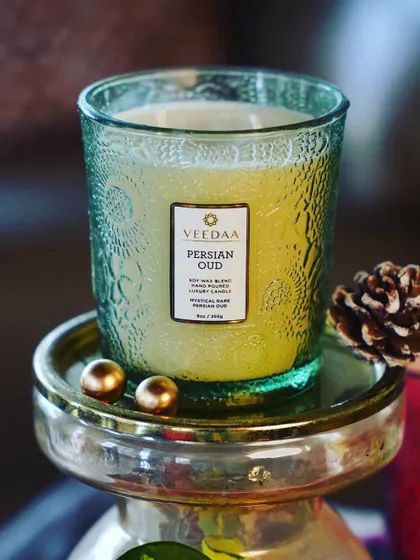 Escape the winter chill with the sultry and mysterious embrace of our Persian Oud candle. The rich, woody fragrance, housed in a green hand-cut glass jar, creates a warm and inviting sanctuary.