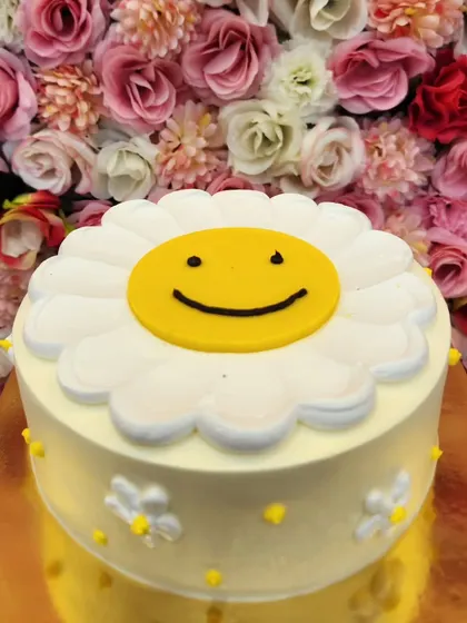 A simple and cheerful smiley face cake. This design is sure to bring a smile to anyone's face.