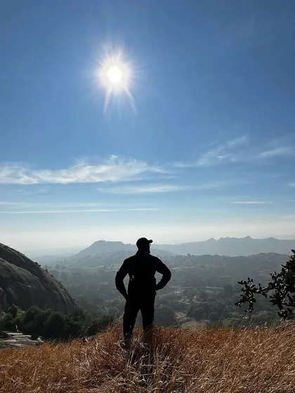 A duplicate of my silhouette against the sun on a mountain peak.