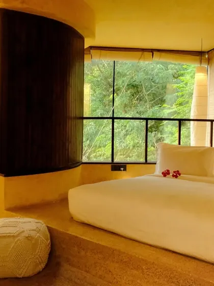 A suite designed for rest and rejuvenation, where the bed becomes a private island of comfort with the forest just beyond the window.