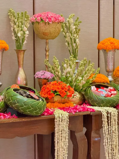 We blended Gujarati and Marwadi aesthetics with Patola prints, gota patti work, heart-themed cushions, and tables laden with marigolds and nostalgic childhood candies.