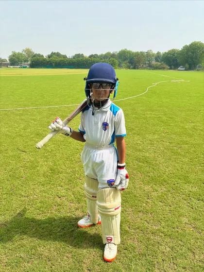 The future of cricket. This young player has the dream in his eyes and the bat in his hand.