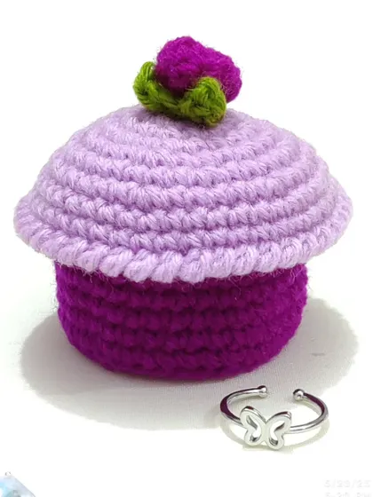 A close-up shot of the cupcake ring box, showing the texture of the crochet stitches.