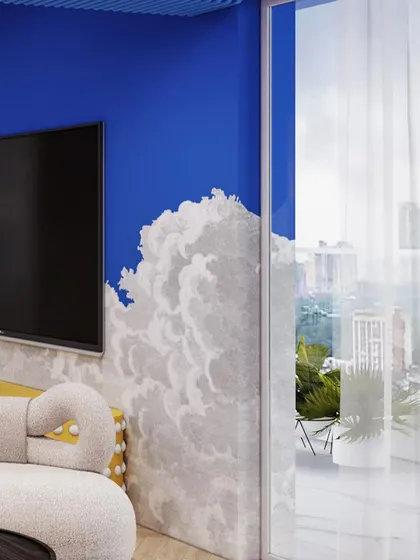 The cloud motif continues on the TV wall, blurring the lines between the wall and the sky outside.